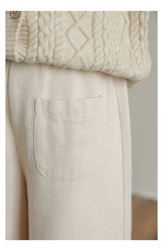 Close up of linen cotton blend trousers with ruffled lace hem and front pockets