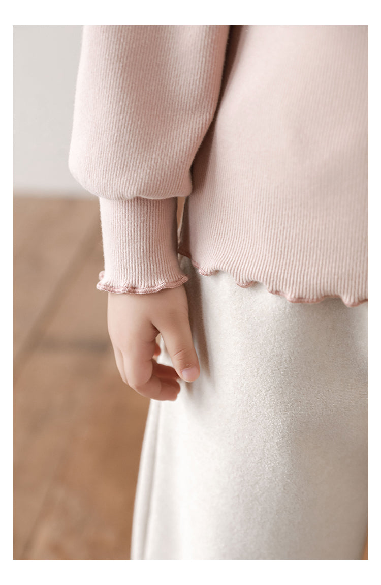 Frilled cuff and hem detail on girls structured top