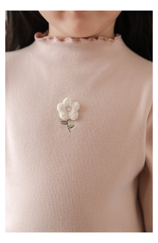 Close-up of floral embroidery on soft stretch girls top