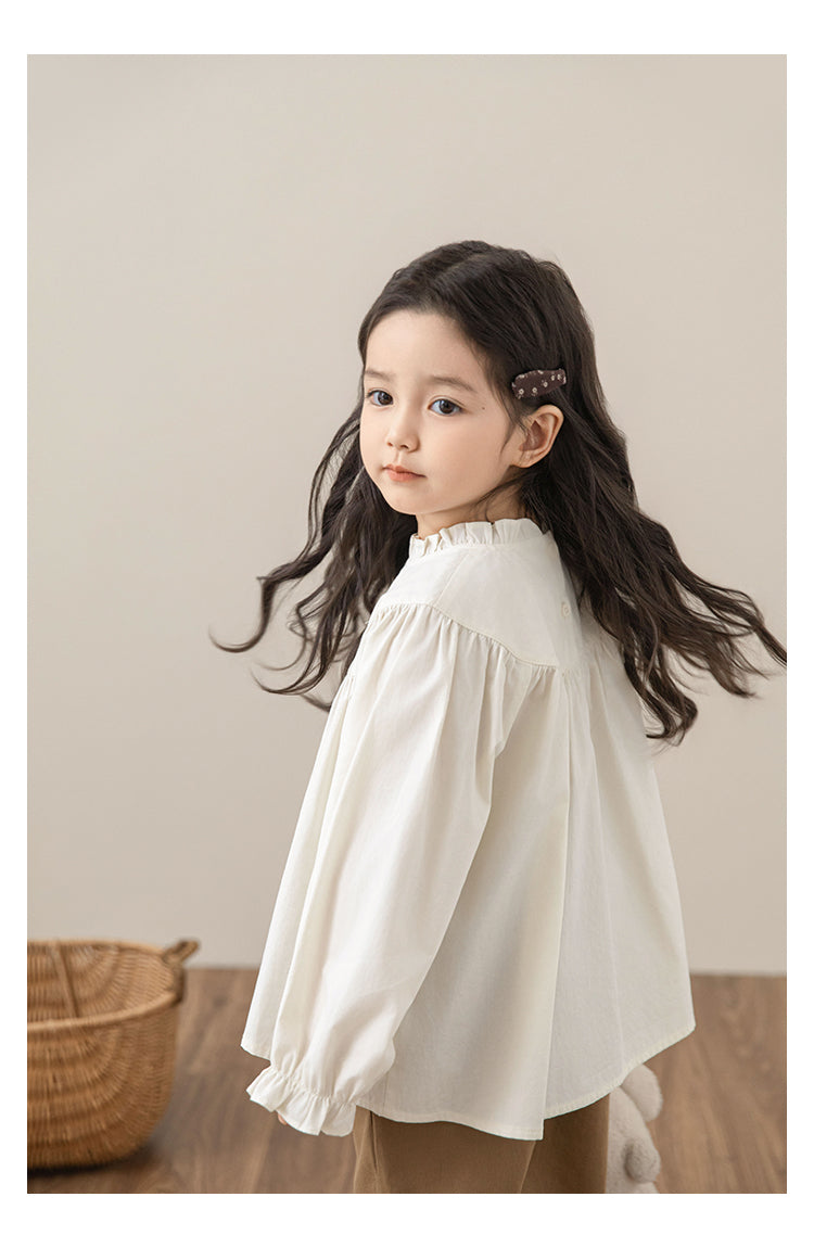 Side view of lightweight girls white cotton blouse with ruffled collar