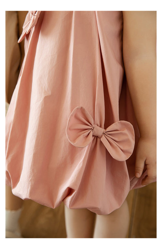 Close-up of playful pleats and puffed hem on girls dress