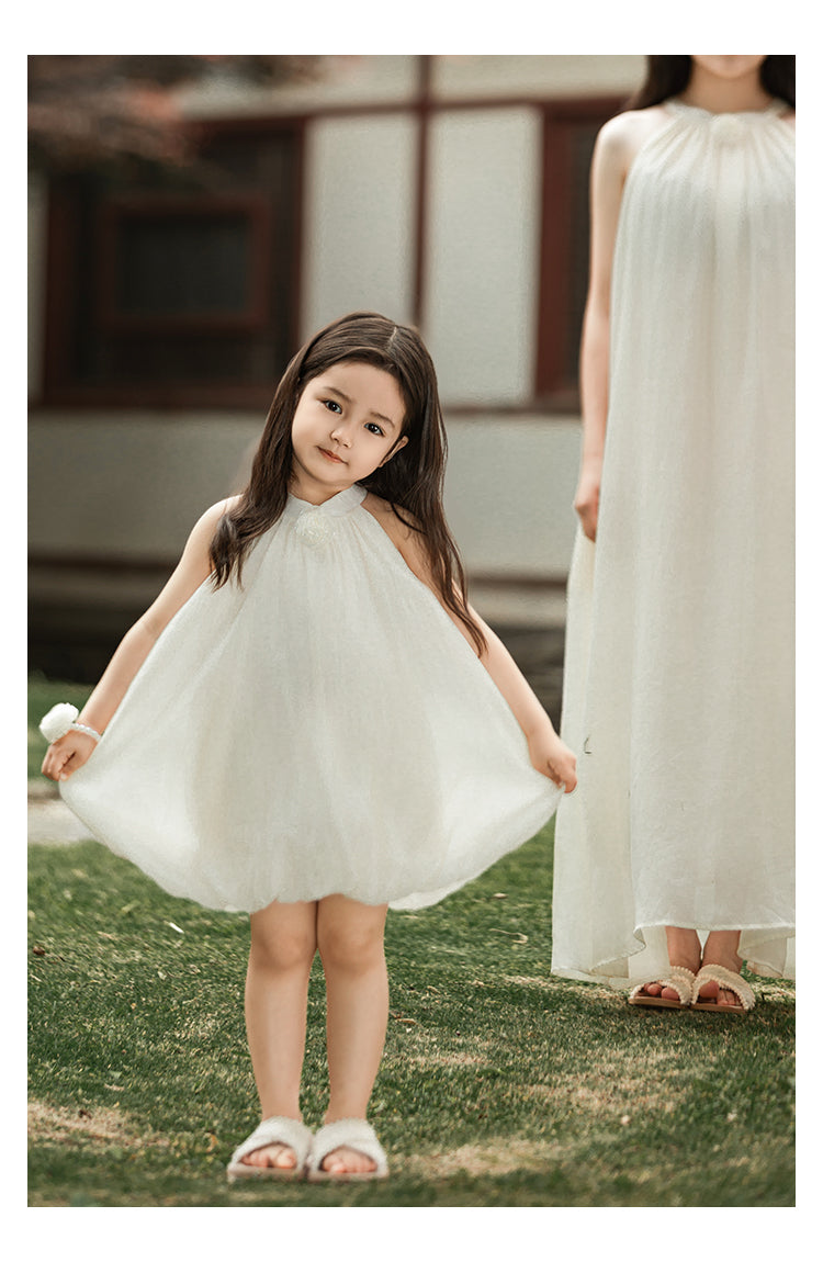 girl wearing summer dress with halter neck and elegant floral accent outdoor