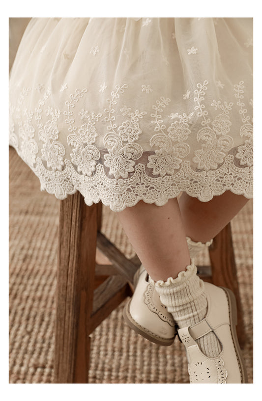 Close-up of lace paneling on soft chiffon girls skirt