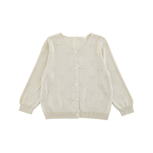 Close-up of heart knit pattern on girls lyocell cardigan in light beige