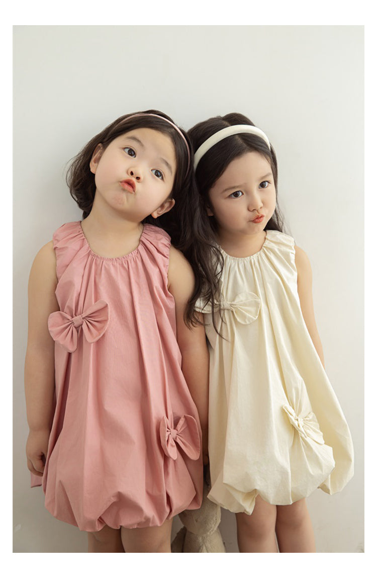 girls wearing elastic neckline dress with bow details
