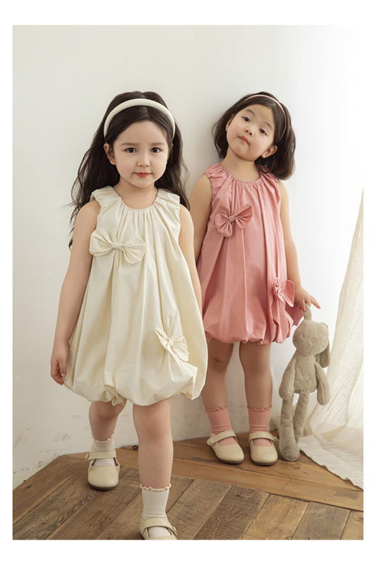 girls wearing dress with girls elastic neckline and playful pleats