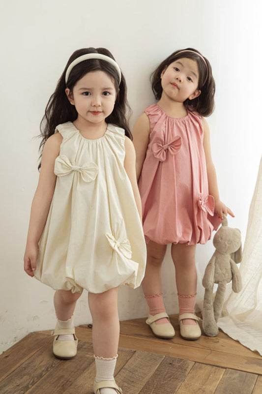 girls wearing dress with girls elastic neckline and playful pleats
