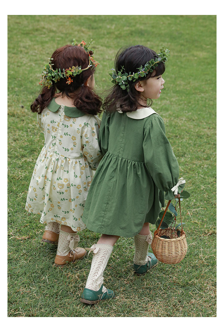 Two young girls in floral dresses from Ava & Bear London