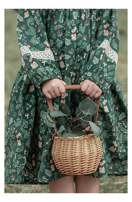 Close-up of lace details on girls green floral dress