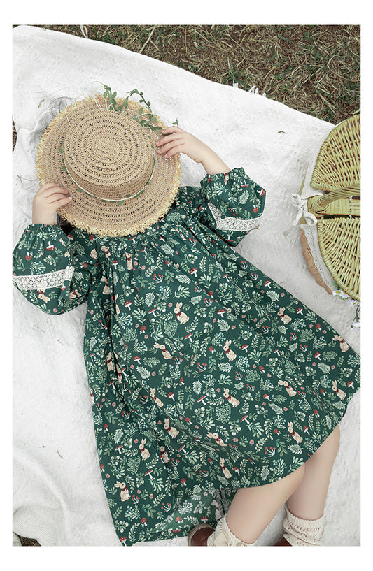 Front view of girls green floral dress with lace trim and puffed sleeves