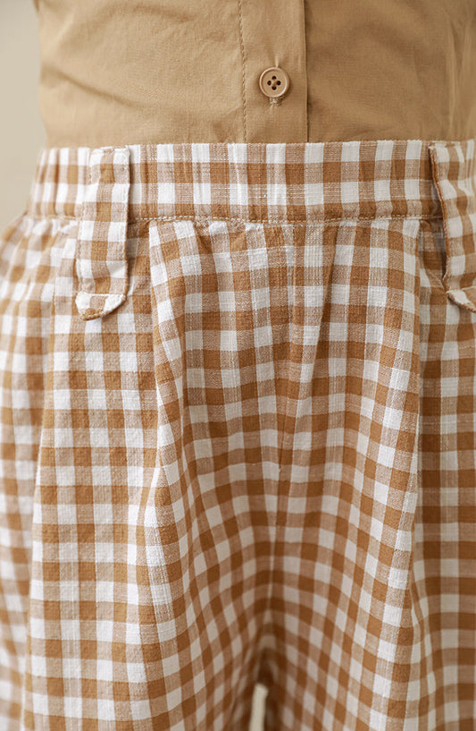 Close-up view of comfortable and elegant girls’ gingham trousers made from lightweight cotton