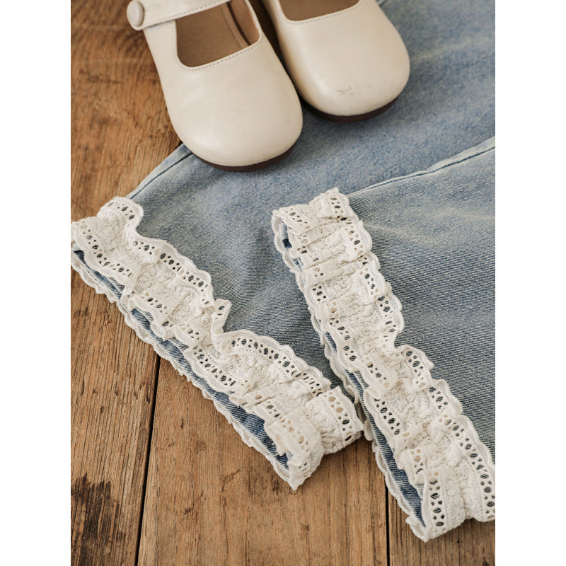 Close up of girls straight leg jeans with lace detail