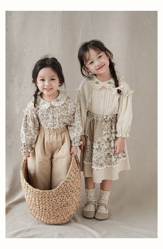 Girls wearing blouse with lace-trimmed collar with flower embroidery