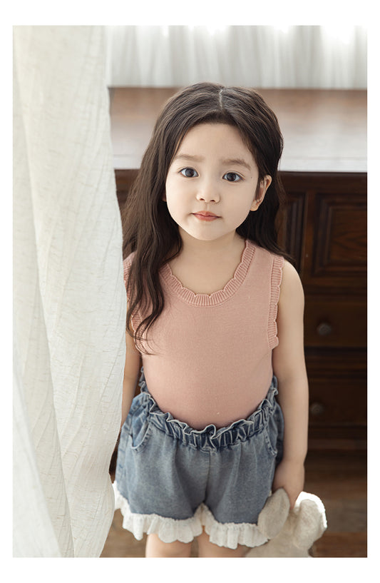 Close-up of scalloped collar detail on girls ribbed tank top