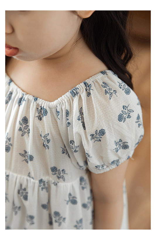 Close-up of charming blue floral prints on breathable cotton blend dress